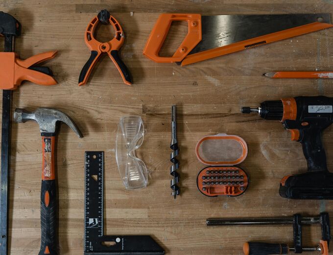 An overhead shot of a variety of different tools such as hammers and drills