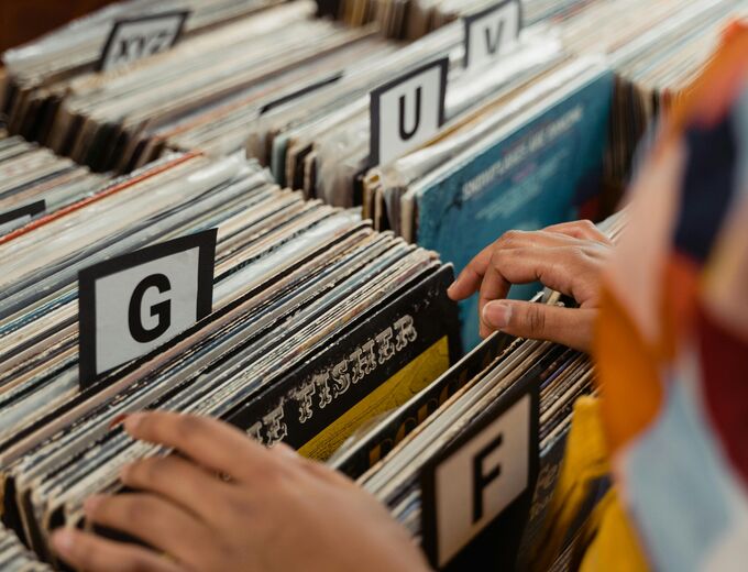 A person looking through music records