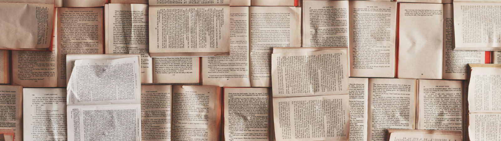 Various open books scattered on top of each other