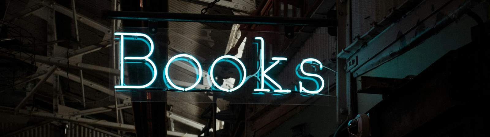 Neon sign in blue that spells out the word "books"